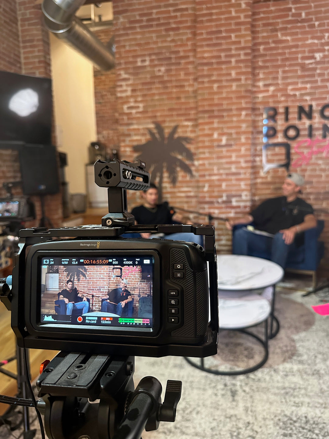 Two people in the studio recording a podcast